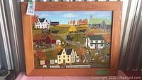 Full front view of framed painting showing farm scene and wooden frame