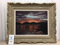 Framed painting of a sunset over water with silhouetted mountains and reflective water, signed by M. Miller.