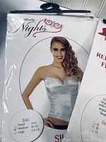 Photo of silver satin corset packaging with model wearing item, showing size medium marked