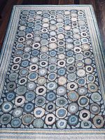 Top-down photo of full 4x6 area rug showing all circular pattern and border in multiple colors.