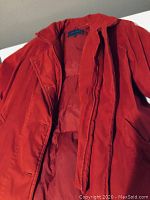 Front view of the red duck down coat showing button and pocket details