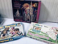 Photo showing three items: Disney Cinderella 3D puzzle box, Mickey's Playground board game, and Mary Poppins carousel game box.