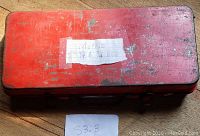 Closed red metal case labeled as metric 1/4 and 3/8 drive socket set