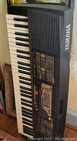 Yamaha PSR-225 keyboard angled to show speaker grille, Yamaha logo, and keys.