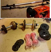 Weight bars, dumbbells, and weight plates displayed on floor