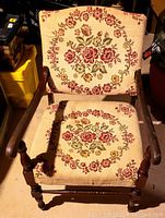 Front view showing cherry wood frame and floral tapestry upholstery on seat and back