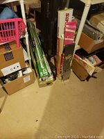 Photo of LED tubes and assorted boxed accent lighting systems on floor next to boxes and furniture