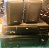 Front view of the stereo receiver and DVD player with KLH speakers on top, showing brand logos and controls.