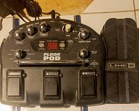 Top view of the Line 6 Floor Pod unit showing all control knobs, footswitches, and power input cable.