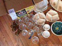 Overhead photo showing Lovenware dishes, Corningware boxes, amber glass cups, plastic compartmentalized bowls, and ashtrays on table.
