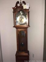 Full view of Seth Thomas grandfather clock showing entire height and wood case