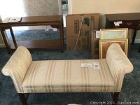 Front view of rolled arm bench showing upholstery and legs.