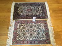 Full view of two modern oriental rugs placed on a wooden floor showing pattern, size and condition.