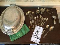 Overview of covered dish, salt cellars, spoons, tongs, and picks