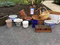 Overview of all flower pots, baskets, and watering can, displaying variety and condition