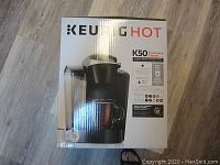 Box of Keurig Hot K50 Classic single serve coffee maker, front view showing machine and water reservoir image with logo and model information.
