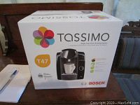 Boxed Bosch Tassimo T47 single cup coffee brewing system showing product image and branding.