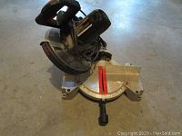 Front angle view of Craftsman 10 inch compound miter saw with visible motor and adjustable miter base.