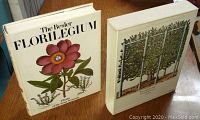 Photo of the hardcover book with dust jacket and slipcase showing front covers with botanical illustrations.