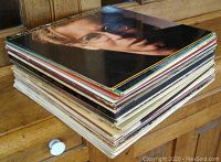 Stack of 24 LP vinyl records, showing thickness and condition of covers and records.
