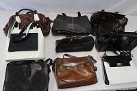 Overview photo showing all 9 handbags from top, arranged in two rows on white surface.