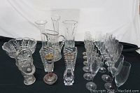 Full display of lead crystal stemware and decorative pieces on black cloth background