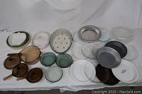 Overview of all glassware, ceramic bakeware, and pie plates on white sheet background