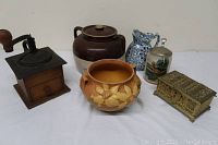Overall lot view showing coffee grinder, beanpot, pottery jar, pitcher, beer stein, and trinket box