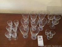 Overview of all 20 glasses on wooden surface showing arrangement and types.