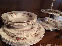 Stacked plates and bowls showing floral pattern and gold trim