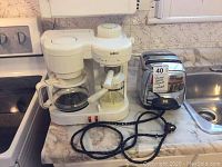Photo of Salton cappuccino maker and vintage stainless steel toaster on countertop showing cord condition and overall appliance appearance.