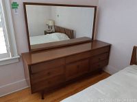 Dresser and mirror from front left angle showing full ensemble