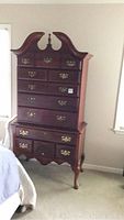Full view of the American Drew cherry wood high boy dresser located in a bedroom setting showing overall profile and condition.