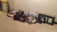 A shot displaying the golf-themed blankets, framed pictures, books, and figures spread on the floor against a wall.