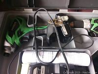 Cordless drill set in carrying case showing charger, drill, and manual.