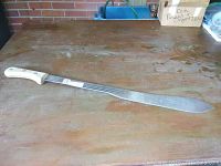 Full length view of a long 28-inch machete with a wooden handle and polished metal blade, showing the item in full.