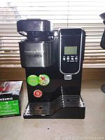 Front view of Hamilton Beach FlexBrew coffee maker showing digital controls and FlexBrew labeling.