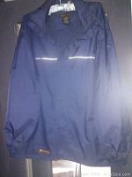 Front view of navy blue men's Wetskins jacket showing reflective stripe near chest and snap buttons at front.