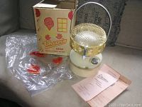 Vintage Therm'x safety heater with original box, plastic wrappings, and paperwork