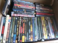 Photo of DVD collection showing various DVDs stacked with titles visible including 'Beef', 'Bowling for Columbine', and 'Training Day'