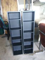 Two black floor standing CD/DVD holder units with three adjustable shelves each, visible from the front.