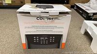 Box of the Cosori CP158AF 5.8 quart air fryer showing the top and front with branding and product features.