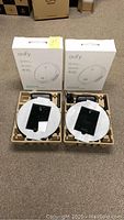 Two boxed Eufy RoboVac 11S units with packaging foam inserts