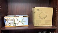 Box showing Vinluz 12-light Sputnik chandelier and a box for LED ceiling light.