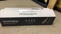 Closed retail box showing the Womow W18 model branding and product type as a cordless vacuum cleaner.