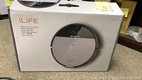 Box of iLife robot vacuum, model V8S, showing front of packaging with product image and model info.