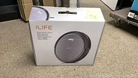 Box of iLife robotic vacuum cleaner Model A4S showing front with image and branding.