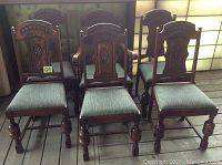 Group of six oak dining chairs arranged in two rows to show overall style and details.