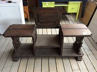 Rustic pine TV stand with two side compartments, central open shelf space, and a hinged top that opens upward, placed on a wooden floor with adjacent furniture.