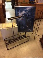 Photo showing hanging light fixture, vintage hamper, framed horse print, and CD holder